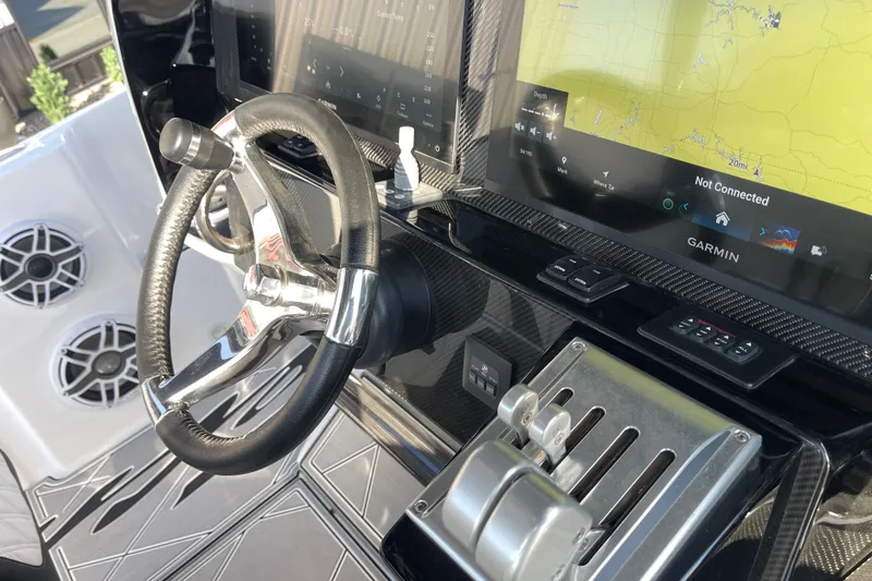 Slide: The Image of 2025 Nor-Tech 340 Sport Center Console helm with Garmin navigation and modern controls. - 20