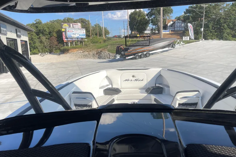Slide: The Image of 2025 Nor-Tech 340 Sport Center Console boat interior view at a dealership. - 23