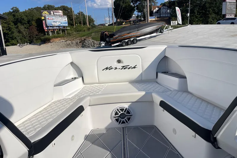 Slide: The Image of 2025 Nor-Tech 340 Sport Center Console boat interior with white seating and speaker. - 25