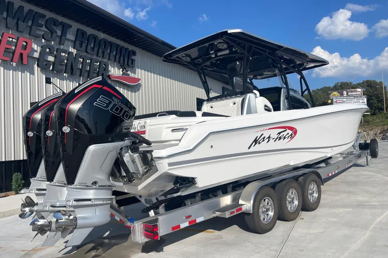 Slide: The Image of 2025 Nor-Tech 340 Sport Center Console boat on trailer at dealership. - 3