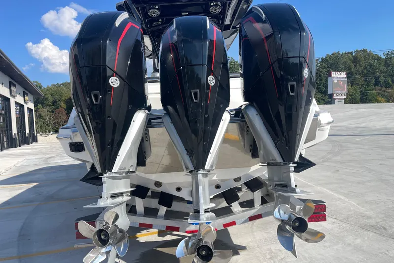 Slide: The Image of 2025 Nor-Tech 340 Sport Center Console with triple outboard engines, rear view. - 5