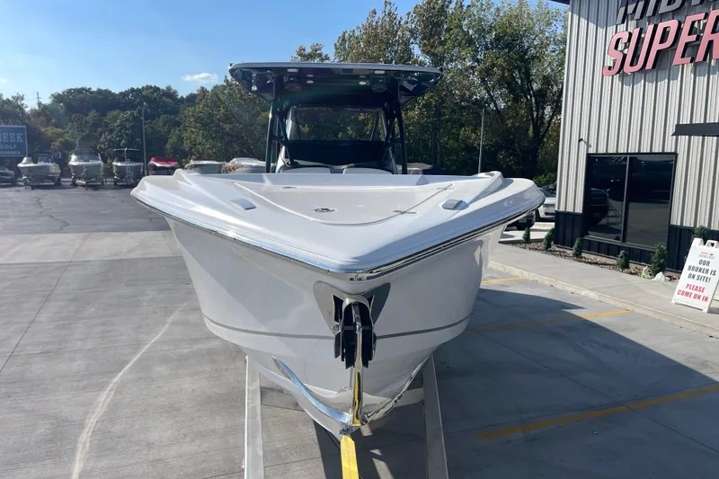 Slide: The Image of 2025 Nor-Tech 340 Sport Center Console boat displayed outdoors at a dealership. - 8