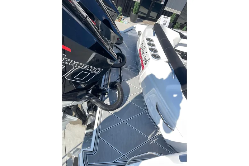 Slide: The Image of 2025 Nor-Tech 340 Sport Center Console boat with powerful engines and sleek deck design. - 9