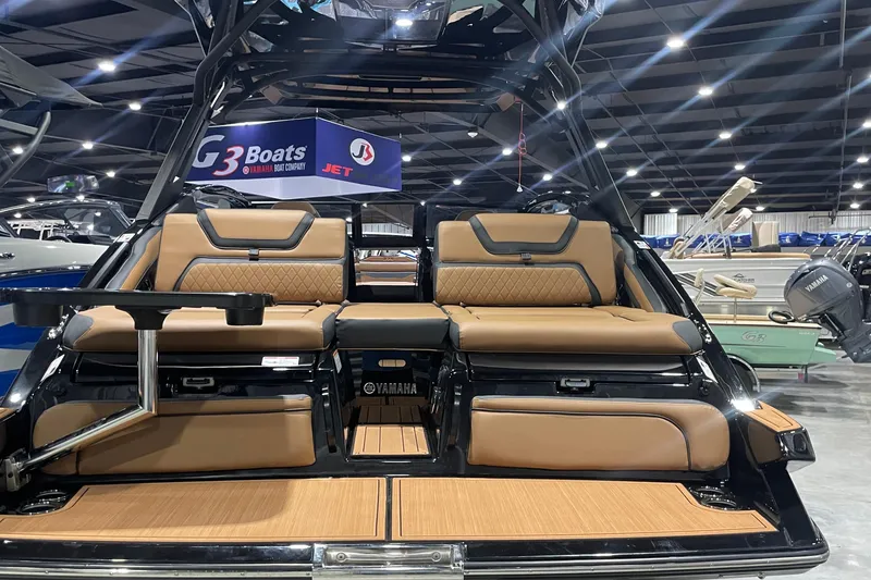 Slide: The Image of 2026 Yamaha Boats 275SD interior with luxurious seating at a boat show. - 2