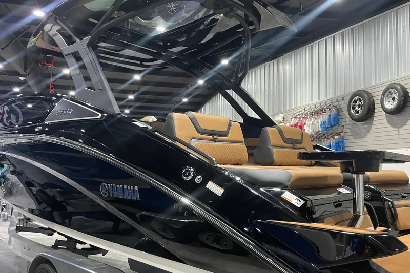 Slide: The Image of 2026 Yamaha Boats 275SD in showroom, sleek design with luxurious seating. - 3