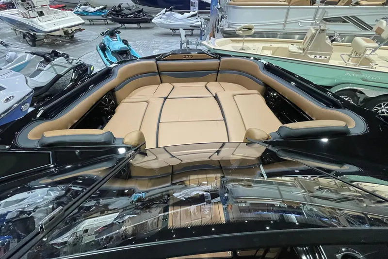 Slide: The Image of 2026 Yamaha Boats 275SD interior with tan seating, showcased at a boat exhibition. - 9