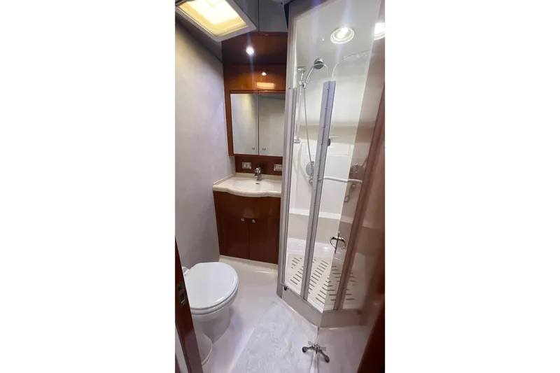 Slide: The Image of Luxurious bathroom in 2005 Bertram 450 yacht with shower, sink, and toilet. - 16