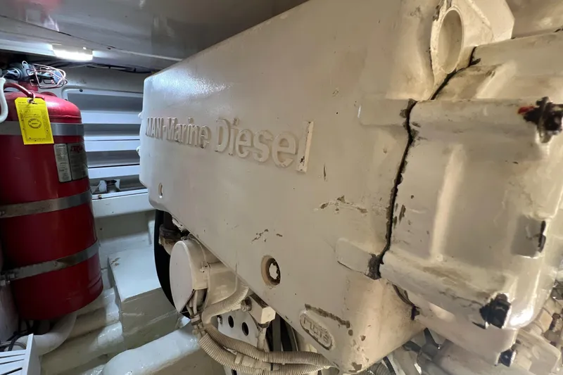 Slide: The Image of Engine room of 2005 Bertram 450 with MAN Marine Diesel engine and fire extinguisher. - 19