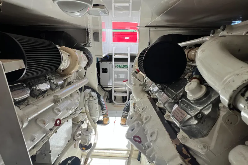 Slide: The Image of Engine room of a 2005 Bertram 450 yacht, showcasing dual engines and mechanical components. - 20