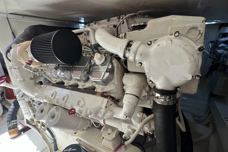 Slide: The Image of Engine of a 2005 Bertram 450 boat, showcasing detailed mechanical components. - 21