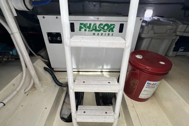 Slide: The Image of Engine room of 2005 Bertram 450 with Phasor Marine generator and Mobil oil container. - 23