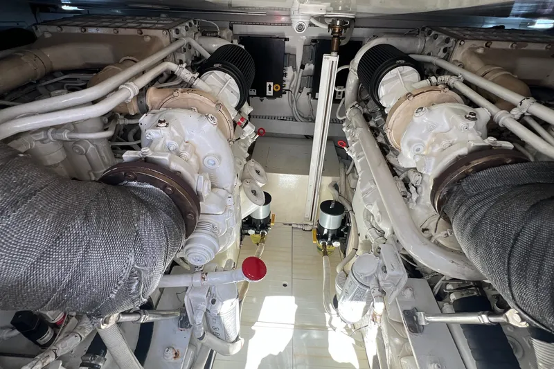 Slide: The Image of Engine room of a 2005 Bertram 450 yacht, showcasing dual engines and mechanical components. - 25