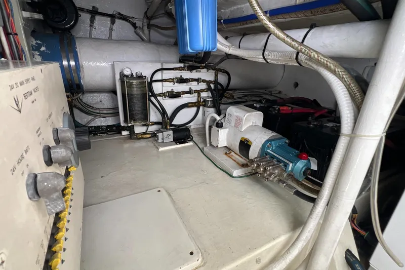 Slide: The Image of Engine room of a 2005 Bertram 450 yacht, showcasing mechanical components and wiring. - 27