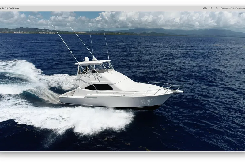 Slide: The Image of A 2005 Bertram 450 yacht cruising on open ocean waters under a cloudy sky. - 33