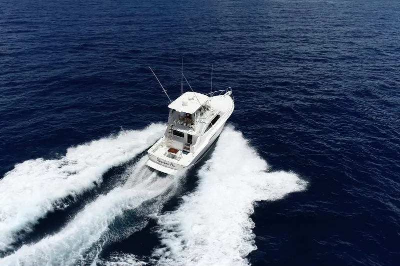 Slide: The Image of Aerial view of 2005 Bertram 450 yacht cruising on open ocean waters. - 43