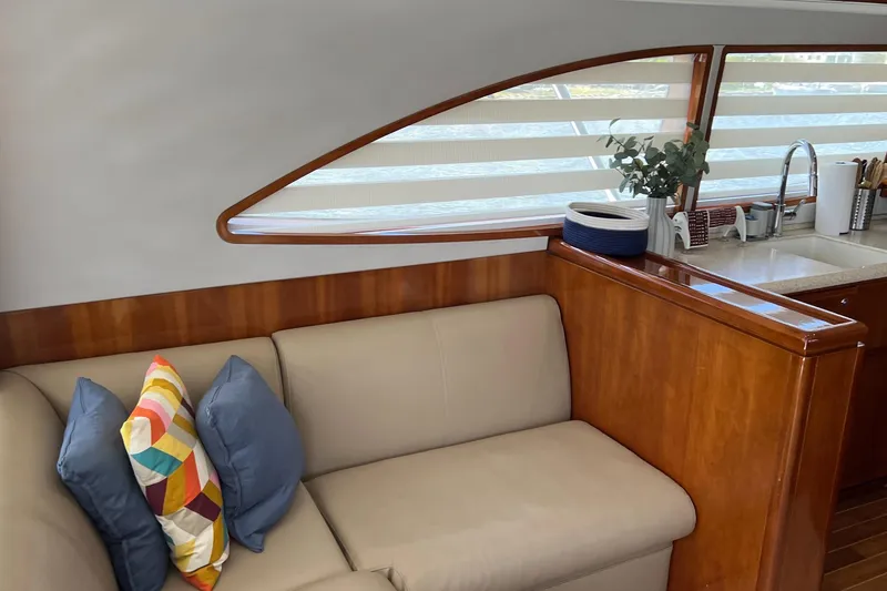Slide: The Image of Interior of 2005 Bertram 450 yacht with cozy seating and modern kitchen area. - 6