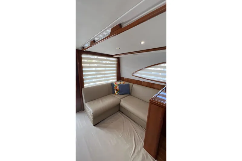 Slide: The Image of Interior of 2005 Bertram 450 yacht with beige seating and decorative pillows. - 7