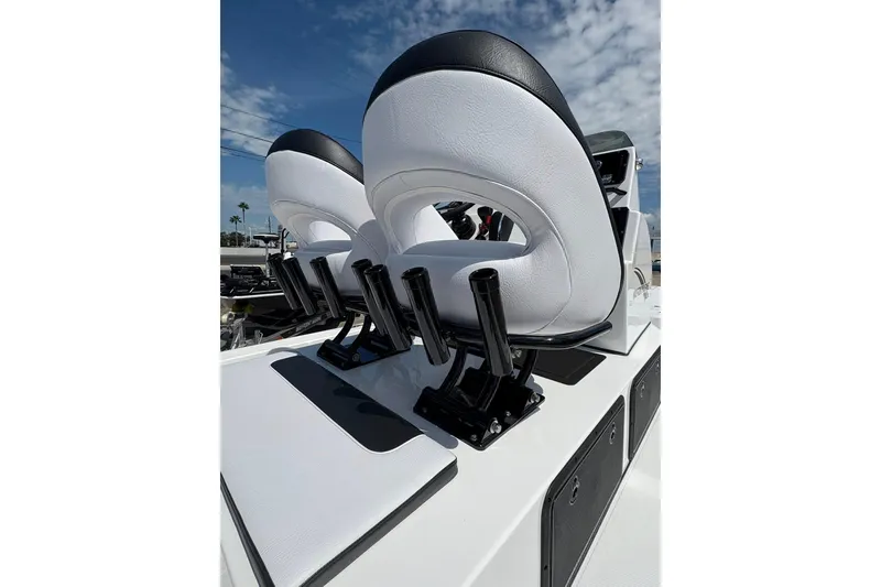 Slide: The Image of Luxury seating on 2026 Mamba 24 Cat Elite boat under clear sky. - 10