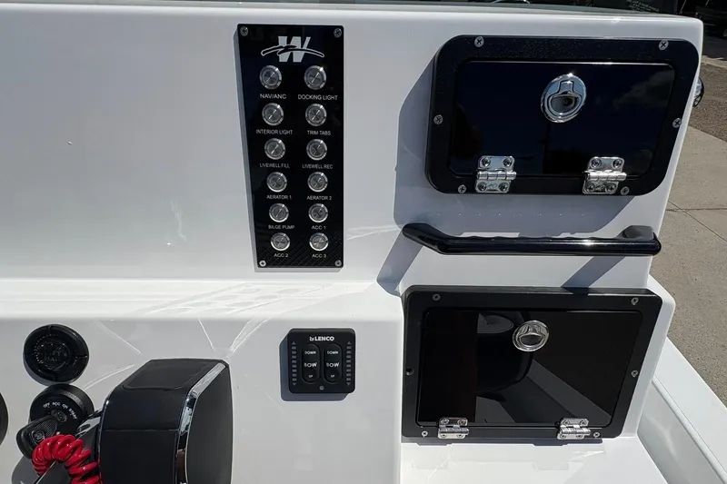 Slide: The Image of Control panel of 2026 Mamba 24 Cat Elite boat with switches and storage compartments. - 13