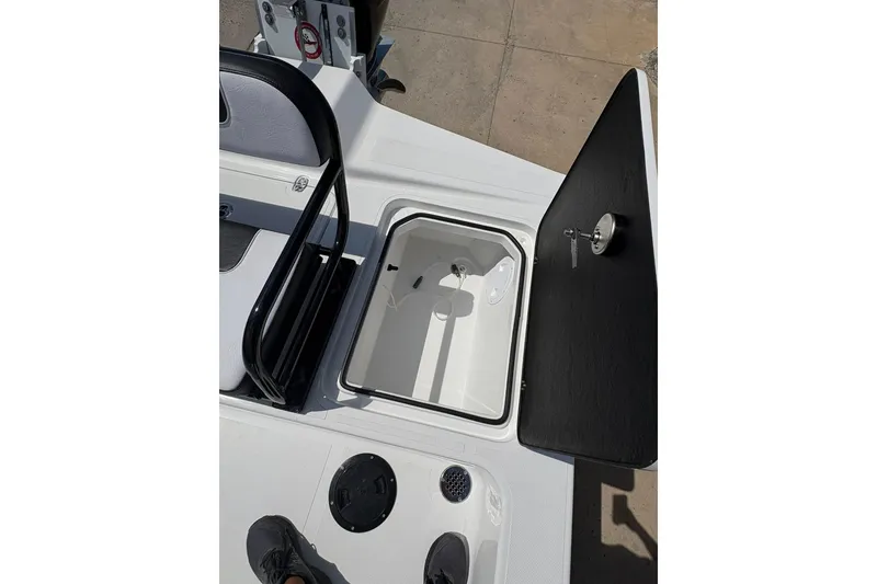 Slide: The Image of Open storage compartment on 2026 Mamba 24 Cat Elite boat deck. - 15