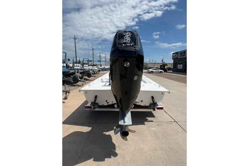 Slide: The Image of 2026 Mamba 24 Cat Elite boat with powerful outboard motor, parked outdoors. - 4