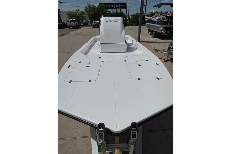 Slide: The Image of 2026 Mamba 24 Cat Elite boat on trailer, sleek white design, outdoor setting. - 5