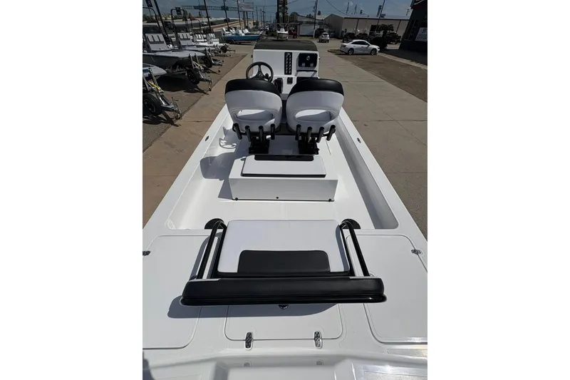 Slide: The Image of 2026 Mamba 24 Cat Elite boat interior with dual seats and control panel. - 9