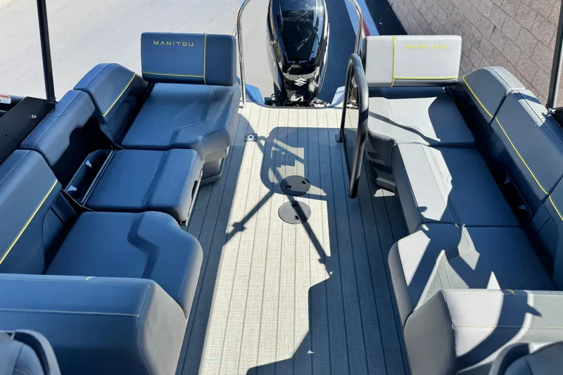 Slide: The Image of 2025 Manitou EXPLORE 24 boat interior with sleek seating and modern design. - 13