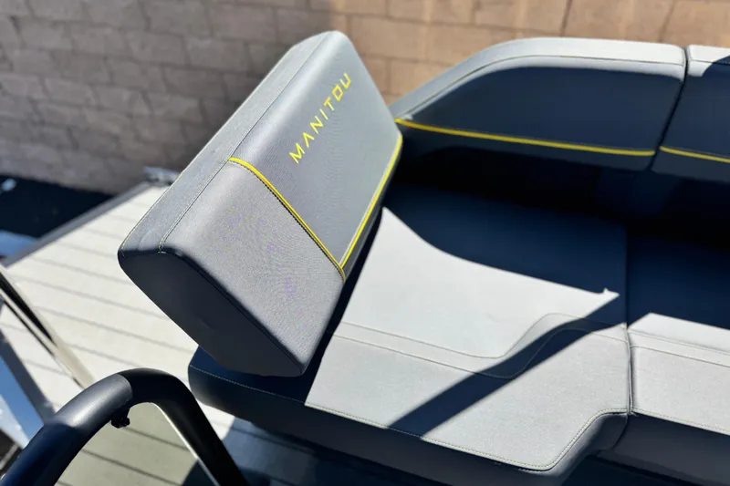 Slide: The Image of Gray seating on 2025 Manitou EXPLORE 24 boat with yellow accents. - 17
