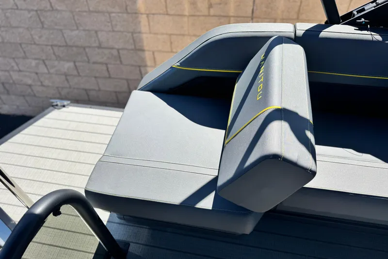 Slide: The Image of 2025 Manitou EXPLORE 24 boat seat with sleek gray upholstery and yellow accents. - 18