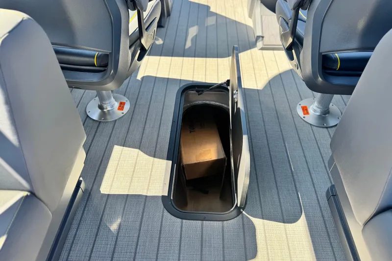 Slide: The Image of Under-seat storage compartment in 2025 Manitou EXPLORE 24 boat interior. - 21