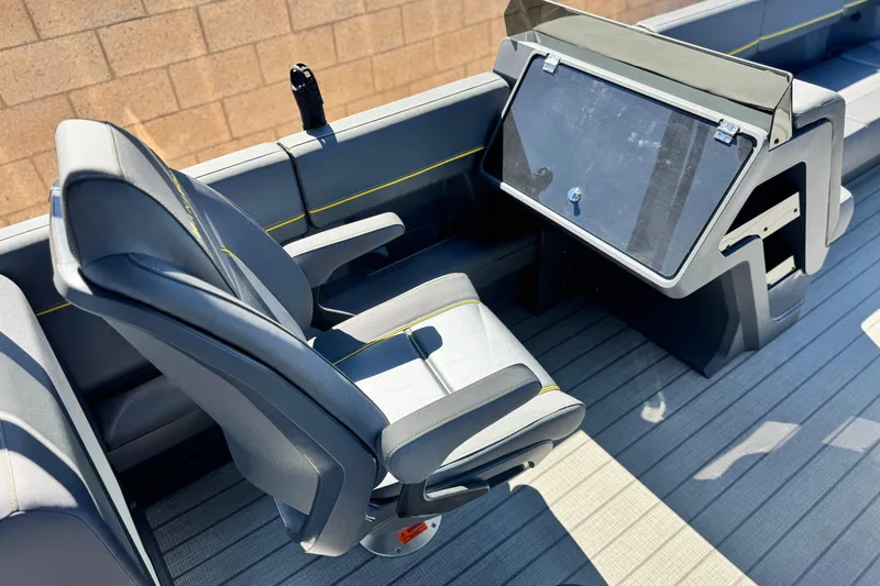 Slide: The Image of 2025 Manitou EXPLORE 24 boat interior with modern seating and control panel. - 22