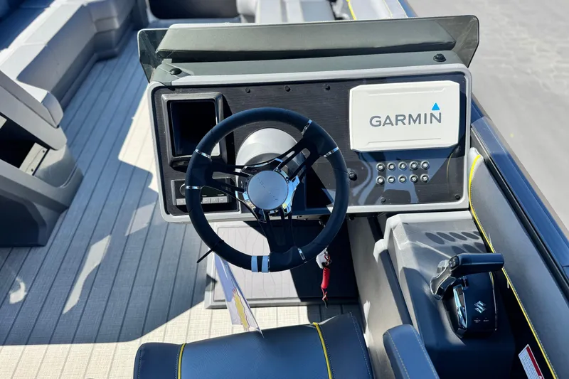 Slide: The Image of Steering console of 2025 Manitou EXPLORE 24 boat with Garmin navigation system. - 24