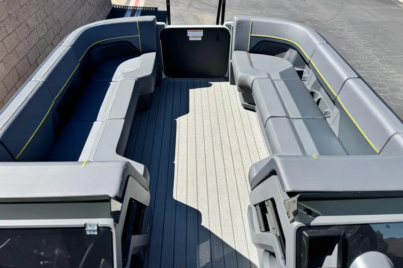 Slide: The Image of 2025 Manitou EXPLORE 24 boat interior with spacious seating and modern design. - 9