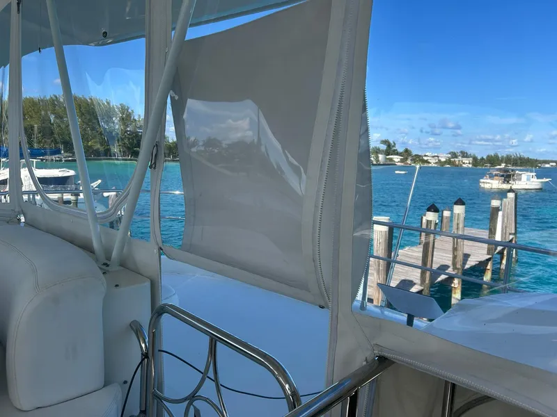 Slide: The Image of 2006 Marquis 65 yacht interior with ocean view and dock in background. - 12