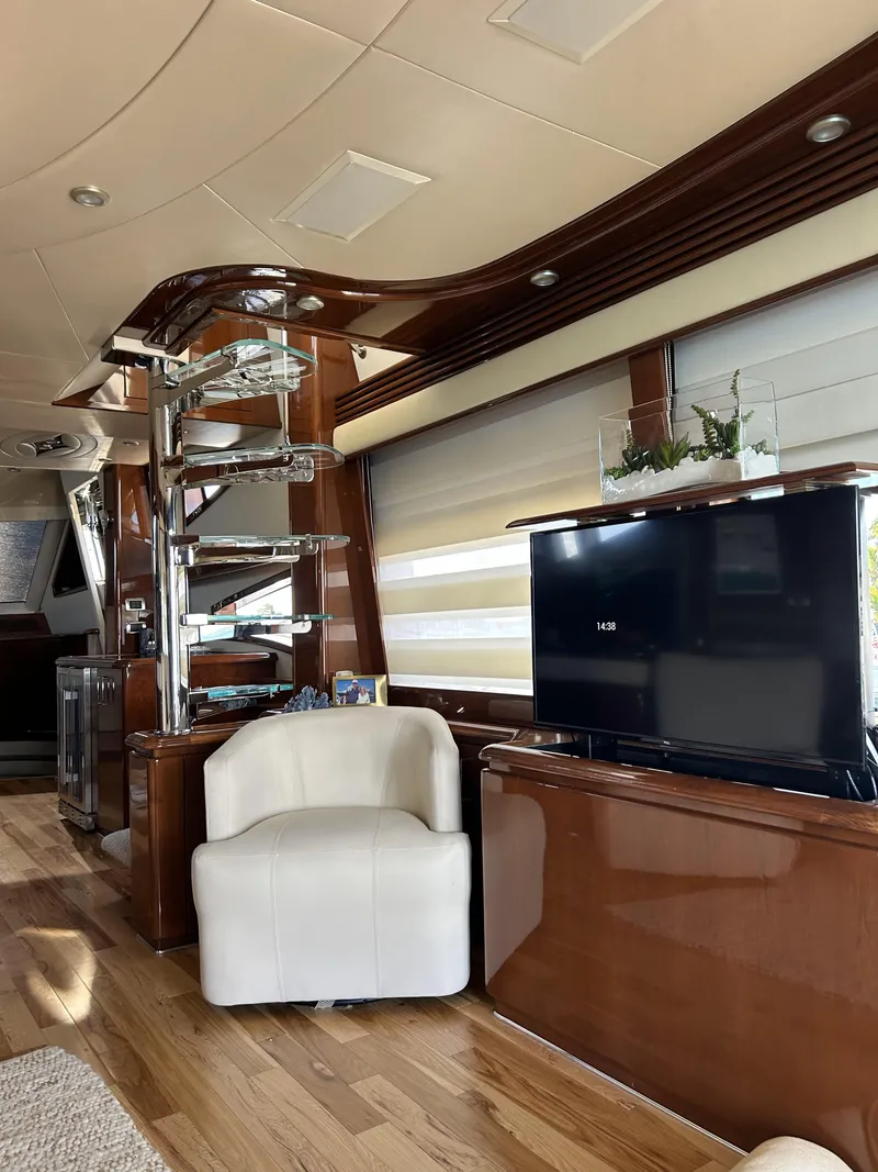 Slide: The Image of Luxurious interior of a 2006 Marquis 65 yacht with modern decor and entertainment setup. - 17