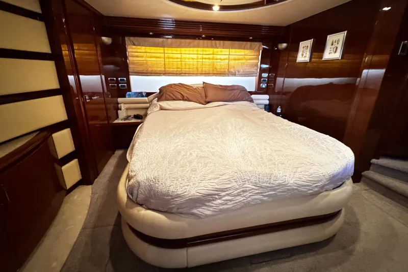 Slide: The Image of Luxurious bedroom interior of 2006 Marquis 65 yacht with elegant wood paneling. - 18