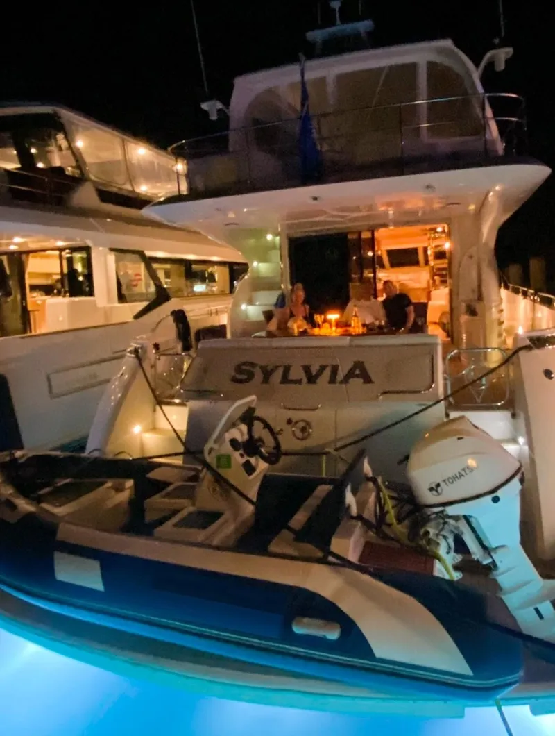 Slide: The Image of Luxury 2006 Marquis 65 yacht "Sylvia" docked at night with illuminated deck. - 19