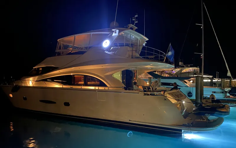 Slide: The Image of Luxurious 2006 Marquis 65 yacht illuminated at night in marina. - 22