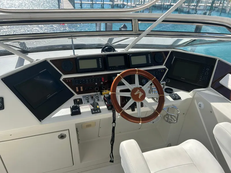 Slide: The Image of 2006 Marquis 65 yacht helm with modern navigation equipment and wooden steering wheel. - 7