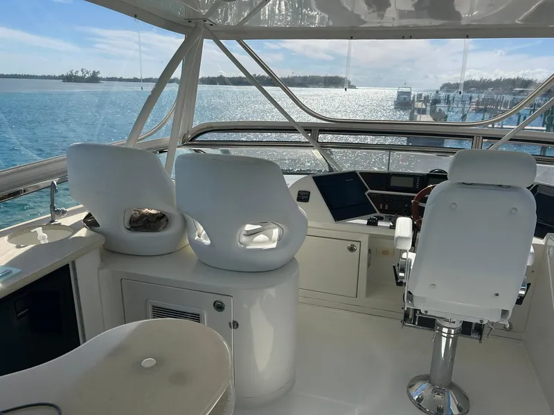 Slide: The Image of 2006 Marquis 65 yacht helm with white seating and ocean view. - 9