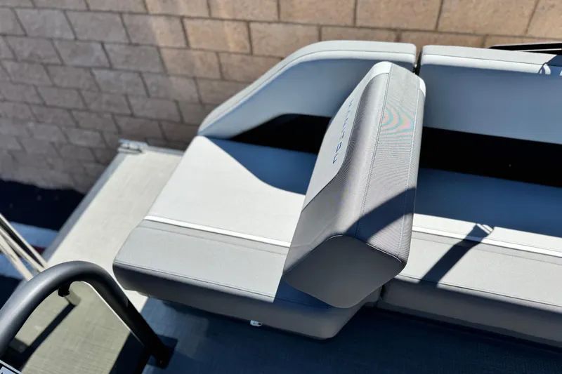 Slide: The Image of 2024 Manitou Cruise 22 boat seat with sleek gray upholstery. - 15