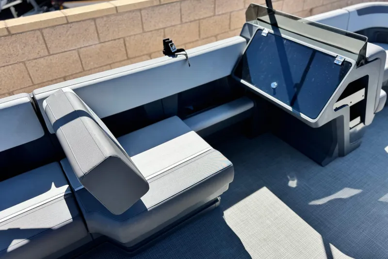 Slide: The Image of 2024 Manitou Cruise 22 boat interior with modern seating and dashboard design. - 18