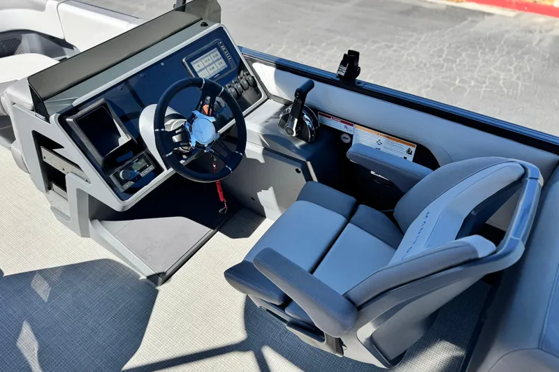Slide: The Image of 2024 Manitou Cruise 22 boat cockpit with modern steering and controls. - 20
