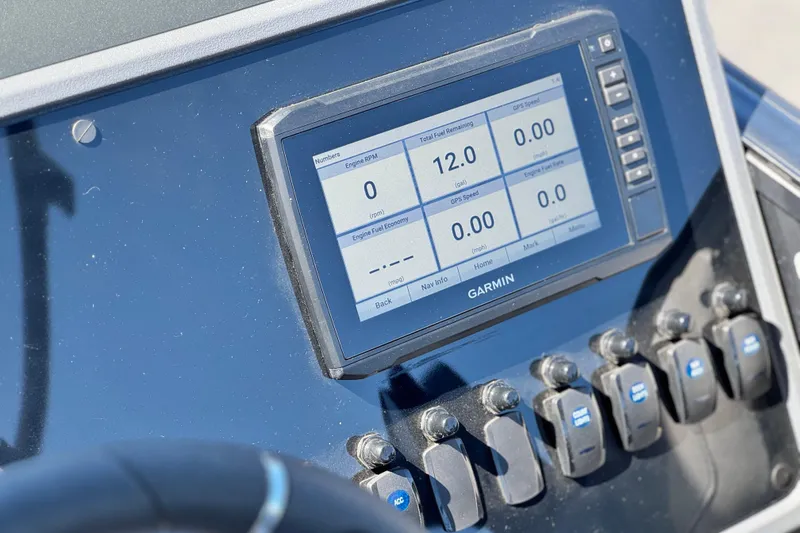 Slide: The Image of Garmin display on 2024 Manitou Cruise 22 boat dashboard, showing engine and fuel data. - 22