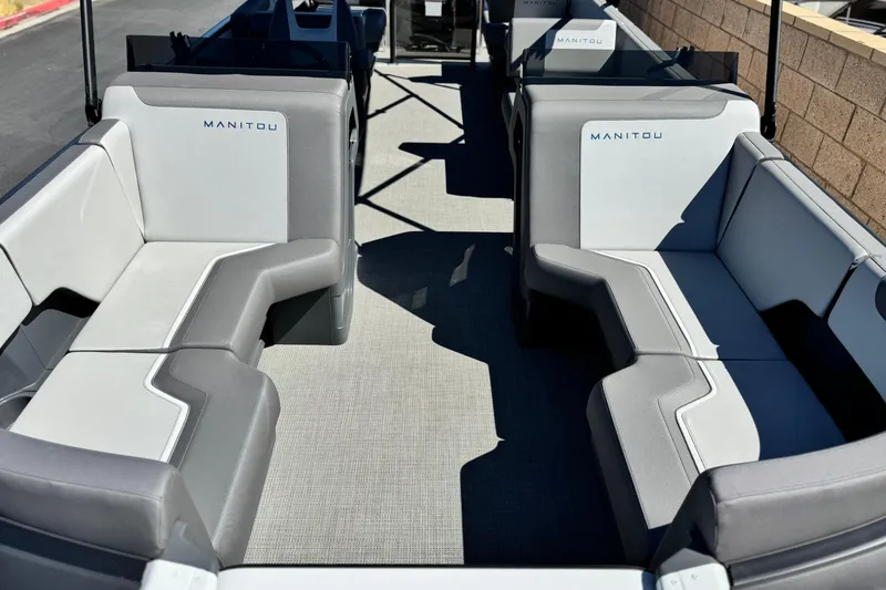 Slide: The Image of 2024 Manitou Cruise 22 boat interior with gray seating and spacious layout. - 8