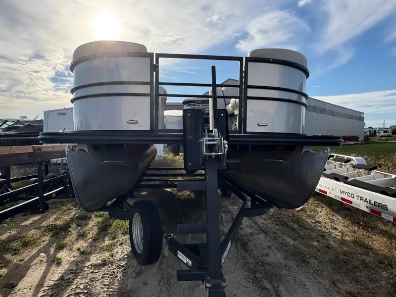 Slide: The Image of 2018 Starcraft CX 23 RE pontoon boat on trailer under sunny sky. - 3