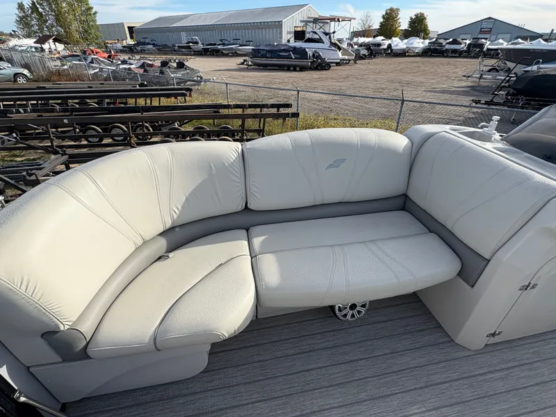 Slide: The Image of 2018 Starcraft CX 23 RE boat with beige seating in a marina setting. - 5