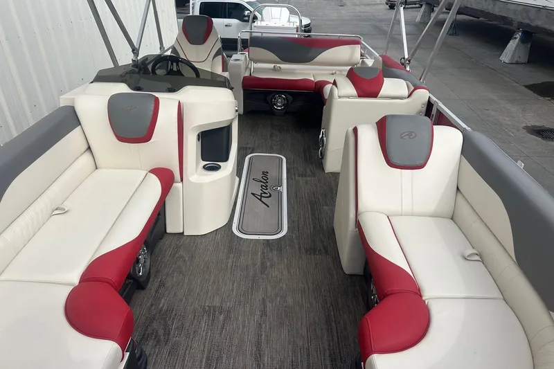 Slide: The Image of 2024 Avalon LSZ 2385 VRB pontoon boat interior with red and white seating. - 10