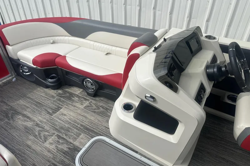 Slide: The Image of 2024 Avalon LSZ 2385 VRB boat interior with red and white seating, modern dashboard. - 16